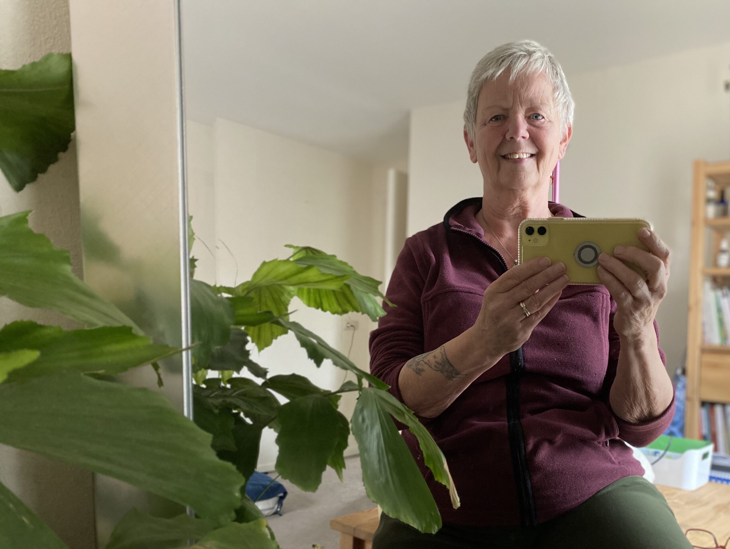 vrouw, 60-er, maakt selfie via spiegel, lachend